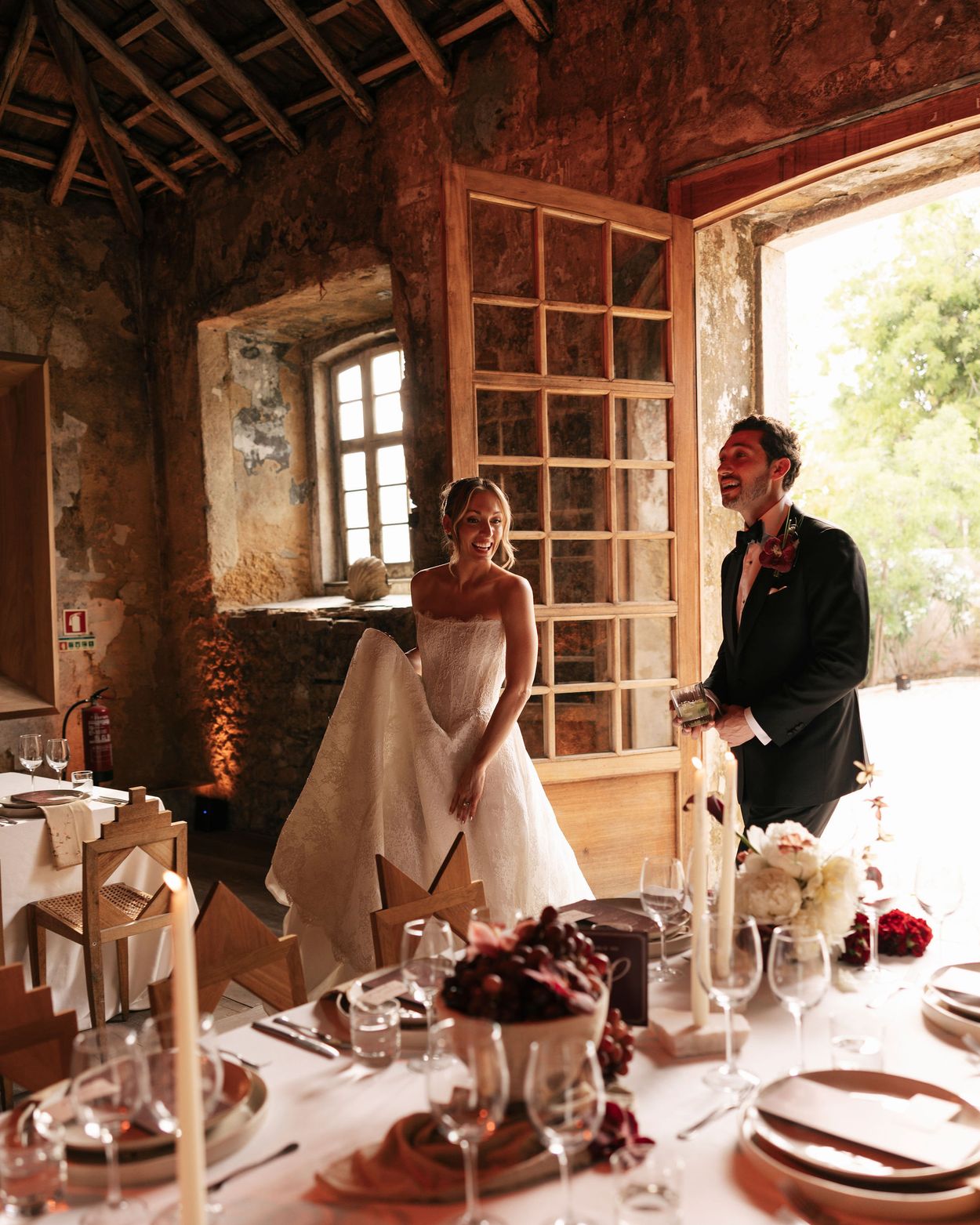 A bride and groom entering the reception room at Pal&aacute;cio do Grilo